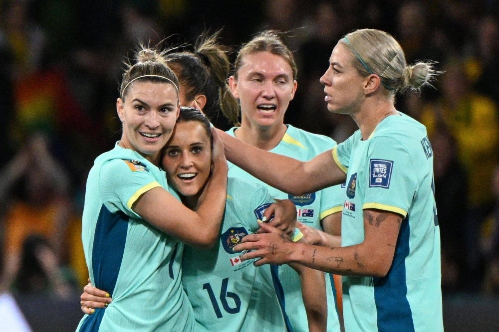 Australian players celebrate after a goal by Haley Raso (second from left) against Canada, during their Group B match at the Women's World Cup in Melbourne on July 31.