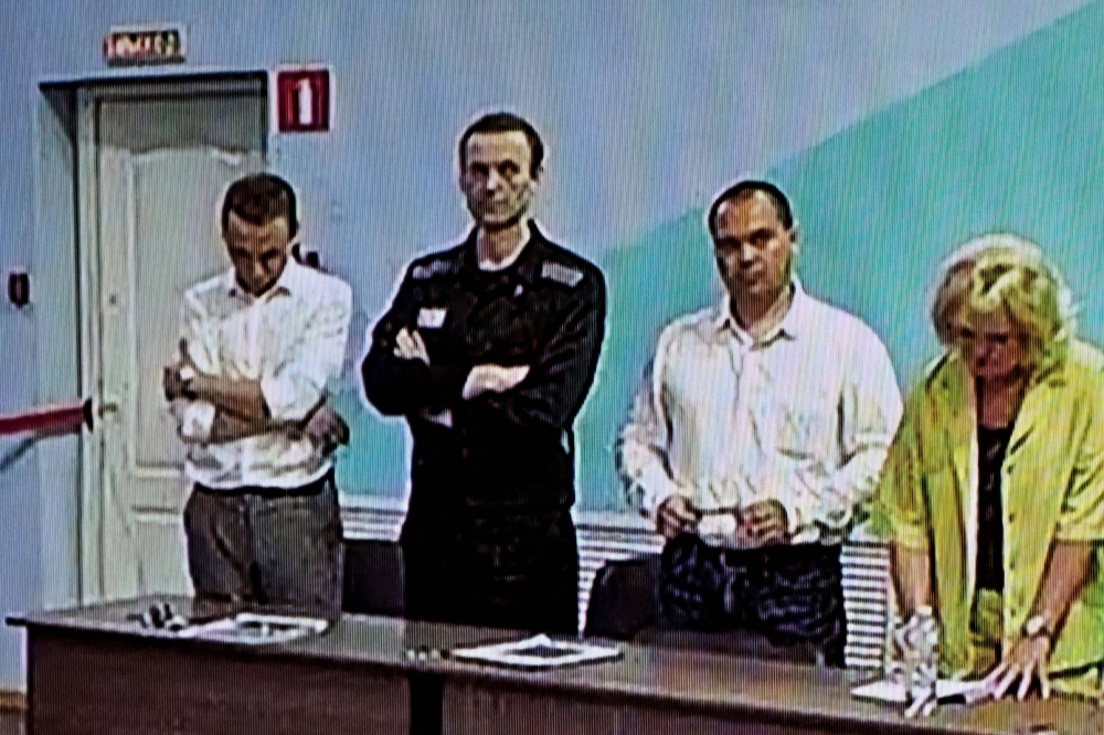 Already imprisoned Russian opposition figure Alexei Navalny (second left) listens to his verdict over a series of extremism charges at the IK-6 penal colony, a maximum-security prison some 250 kilometers (155 miles) east of Moscow, on Friday.