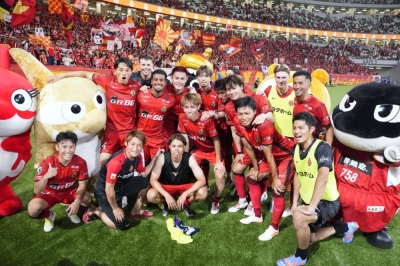 Grampus players celebrate their win over Albirex at Tokyo's National Stadium on Saturday.