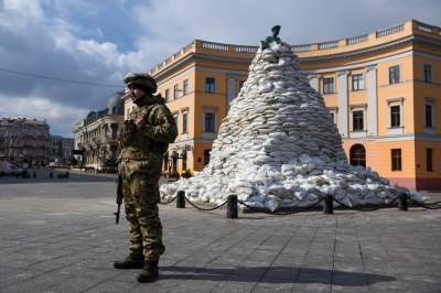 A Ukrainian soldier stands guard next to Odesa's famous statue of the city's founder, Duke de Richelieu, in March 2022.

 