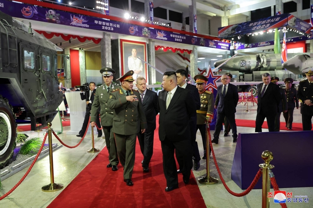 North Korean leader Kim Jong Un and Russia's Defense Minister Sergei Shoigu visit an exhibition of military equipment on July 27.