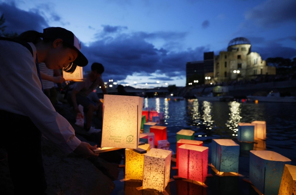 A girl floats a lantern down the Motoyasu River in front of Hiroshima's Atomic Bomb Dome on Sunday, the 78th anniversary of the U.S. nuclear attack on the city.