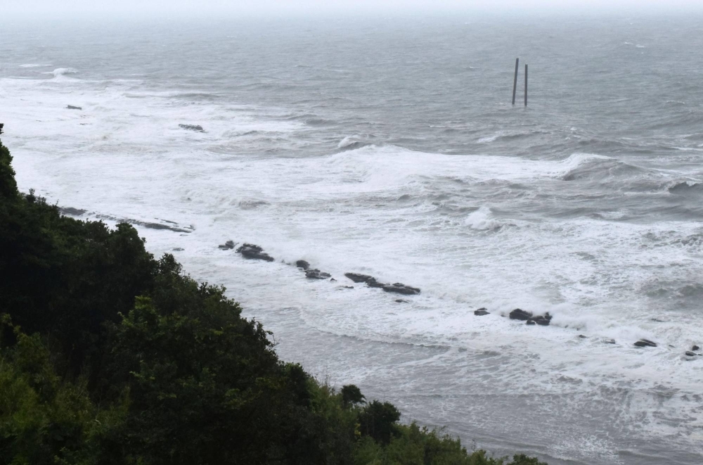 High waves roll onto the coast of Miyazaki Prefecture on Tuesday as Tropical Storm Khanun slowly approaches the Kyushu region.