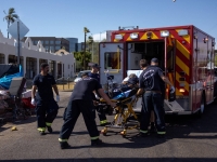 Firefighter EMT personnel assist a man in Phoenix, Arizona, who collapsed during a 27-day-long heat wave with temperatures over 43 degrees Celsius. | REUTERS