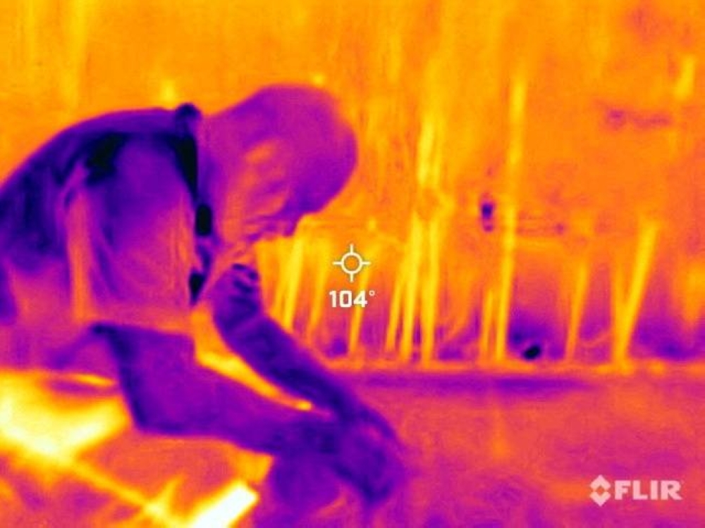 A landscape worker from Mexico takes a break during a heat wave in Phoenix, Arizona, on July 27. A thermal camera registered surface temperatures of 40 degrees Celsius, with an air temperature of 42 C.