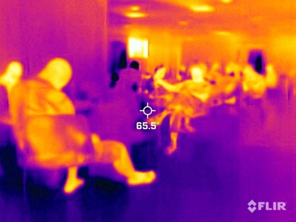 Unhoused people sit inside a cooling station during a heat wave in Phoenix, Arizona, on July 26. A thermal camera registered a surface temperature of 18 C, with an air temperature of 36 C.