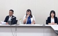 Yukiko Kuwazuru (center), a member of the Shibuya Ward Assembly, speaks during a news conference in Tokyo on Monday. | Kyodo