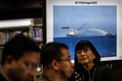 Footage of a Chinese Coast Guard ship using a water cannon against a Philippine resupply vessel is shown during a news conference at the Department of Foreign Affairs in Manila on Monday.