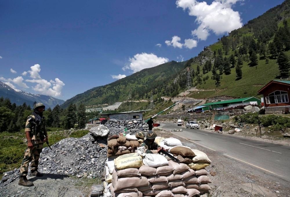 Indian border security force soldiers stand guard at a checkpoint along a highway leading to Ladakh in Kashmir's Ganderbal district in June 2020.  