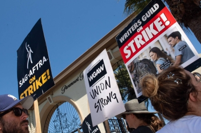 Members of the Writers Guild of America and the Screen Actors Guild-American Federation of Television and Radio Artists walk a picket line outside of Paramount Pictures in Los Angeles. Hollywood actors and writers are currently on strike, effectively bringing the giant movie and television business to a halt in the first industry-wide walkout in 63 years.