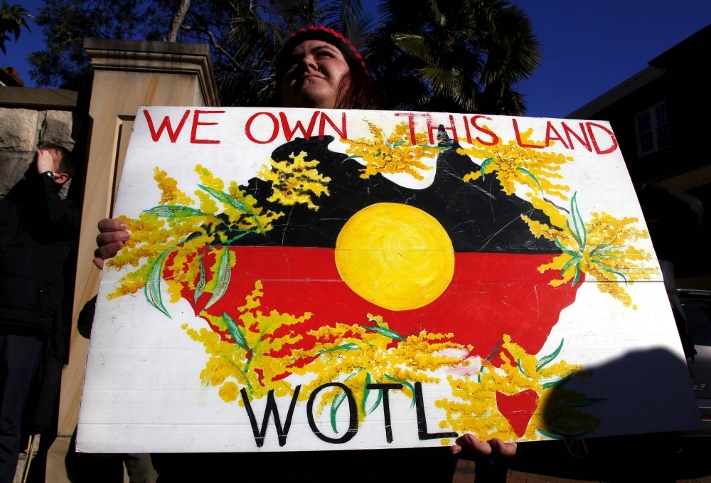 A protester outside a meeting between then-Australian Prime Minister Tony Abbott and Indigenous leaders in 2015. Discussions around a referendum on whether to recognize Indigenous people in the Australian constitution have been held for years, and the vote will be held soon.