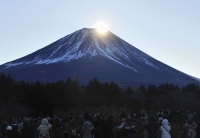 Yamanashi Prefecture will work with police to restrict the number of hikers who can use a route to climb to the summit of Mount Fuji if it becomes dangerous from overcrowding. | Kyodo