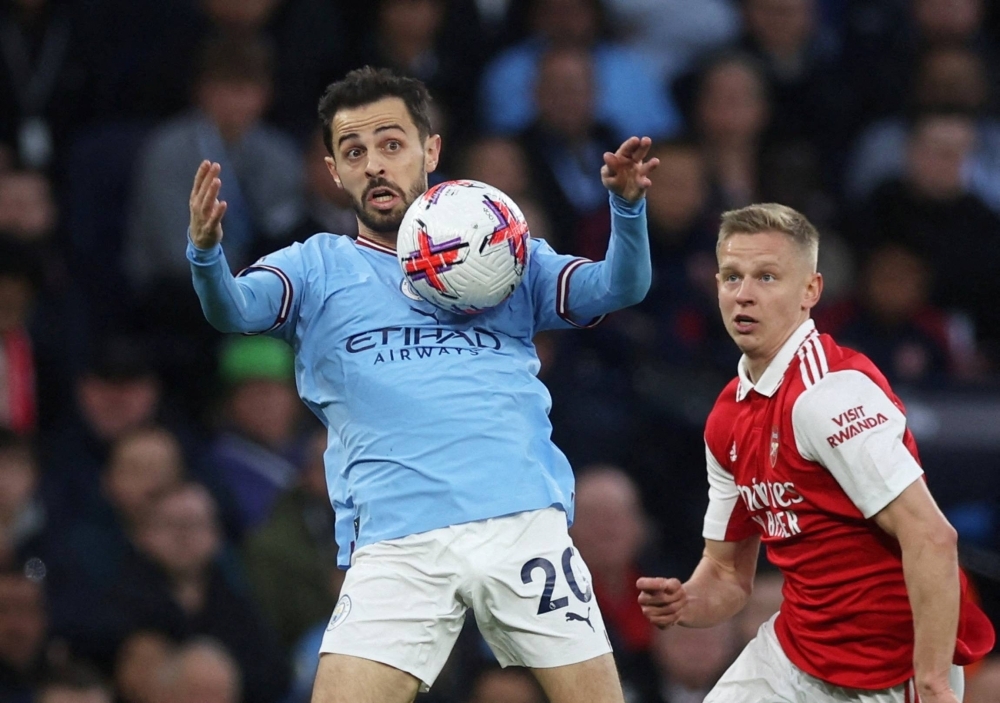 Manchester City's Bernardo Silva (left) controls the ball in front of Arsenal's Oleksandr Zinchenko during their match in Manchester, England, on April 26.