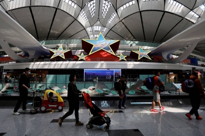 Travellers walk through Beijing Daxing International Airport on April 24.