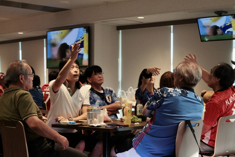 Nadeshiko Japan fans react during a watch party Friday at Saitama Stadium for the team's World Cup quarterfinal. 