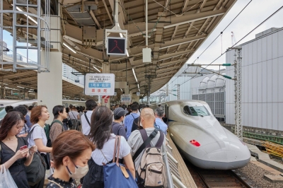 Passengers queue to board a shinkansen bullet train at Tokyo Station in Tokyo on Friday.