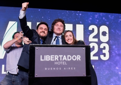Argentine presidential candidate Javier Milei (center) on stage at his campaign headquarters on the day of Argentina's primary elections, in Buenos Aires on Sunday