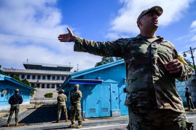 A United Nations Command soldier conducts a media tour of the Demilitarized Zone separating the two Koreas as a South Korean soldier and other UNC soldiers stand guard at the Joint Security Area in the truce village of Panmunjom last October.