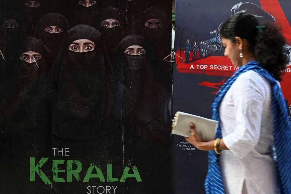 A moviegoer walks past a poster of the film "The Kerala Story" at a movie theater in Mumbai on May 10. 