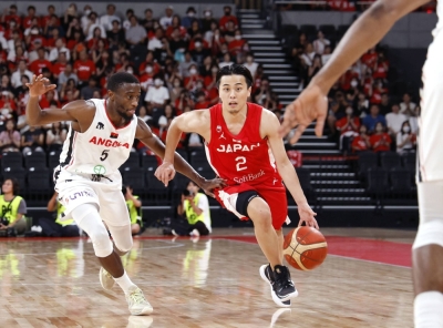 Japan's Yuki Togashi (right) attacks the Angola basket during the fourth quarter of an international friendly at Ariake Arena on Tuesday.