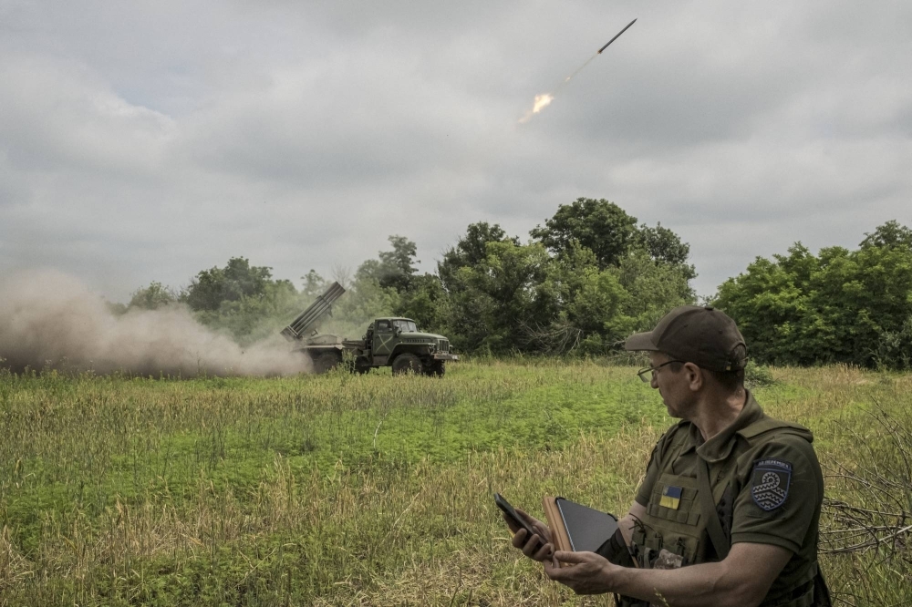 A Ukrainian soldier coordinates as his team fires a rocket in the Donetsk region of Ukraine in June. Ukraine claims that its forces have driven further into the Mokri Yaly River Valley in the south of the country, announcing Wednesday that they had retaken the tiny village of Urozhaine.