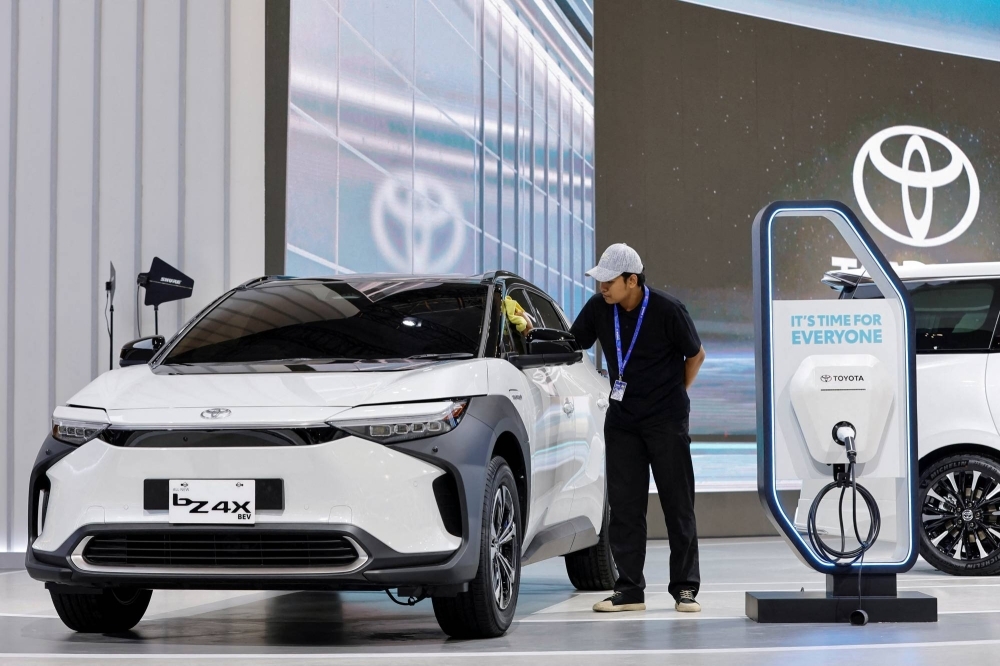 A worker cleans a Toyota Electric Vehicle bZ4X on display during the Gaikindo Indonesia International Auto Show in Tangerang, near Jakarta, Indonesia, last week.