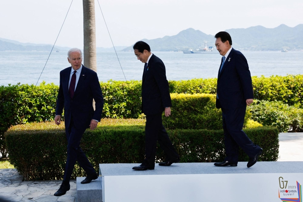 U.S. President Joe Biden, Prime Minister Fumio Kishida and South Korean leader Yoon Suk-yeol attend a photo op on the day of trilateral engagement during the Group of Seven summit in Hiroshima in May.