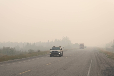 Vehicles leave Yellowknife on the only highway in or out of the city after a state of emergency was declared due to the proximity of a wildfire, in Yellowknife, Northwest Territories, Canada, on Wednesday.