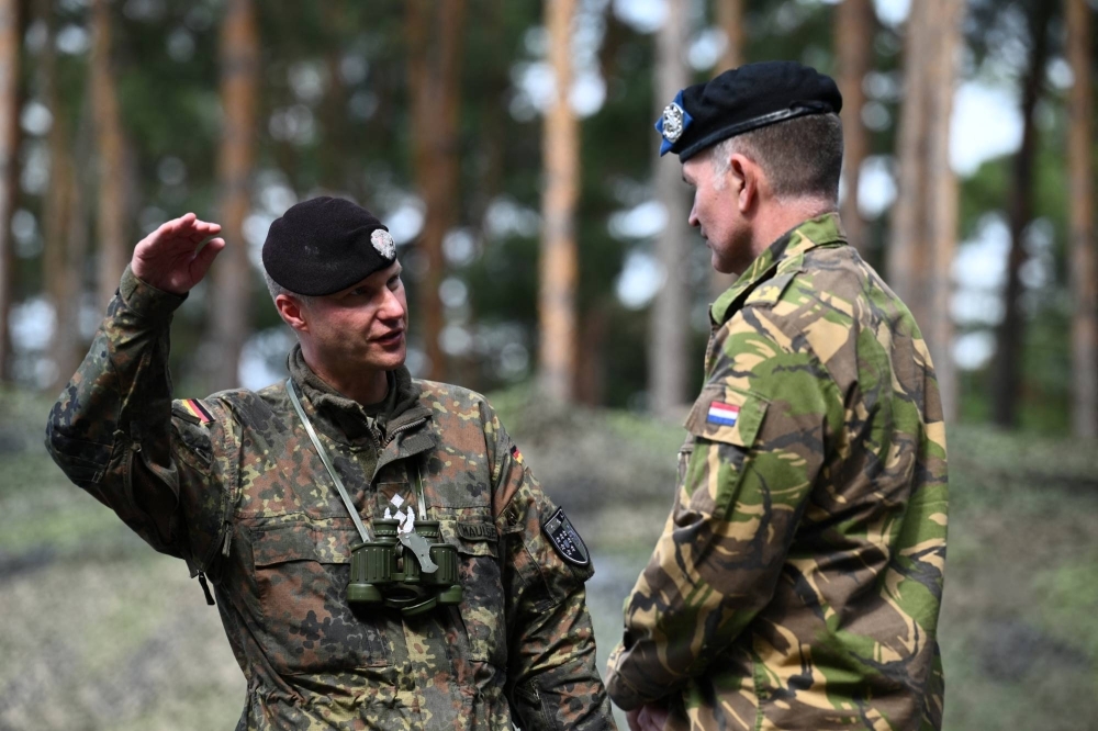 Lt. Col. Marco Maulbecker (left), training manager on the Leopard 1A5, in Klietz, Germany, on Thursday