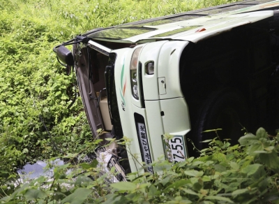 An overturned high-school soccer club bus is seen Saturday in the city of Kagoshima.