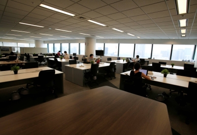People work in an office where the majority of staff work remotely at the headquarters of Fujitsu in Tokyo in August 2020.