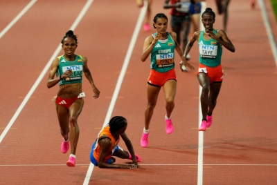 Ethiopia's Gudaf Tsegay (left) runs past fallen Dutch runner Sifan Hassan (second from left) to win the women's 10,000-meter final at the World Athletics Championships in Budapest on Saturday.