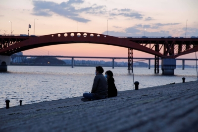 A couple enjoy the sunset in Seoul. The proportion of people getting married has declined worldwide, but it has plummeted especially far in South Korea.