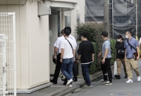 Investigators from Tokyo Metropolitan Police Department search the dormitory of the Nihon University American football team in Tokyo's Nakano Ward on Tuesday. | Kyodo