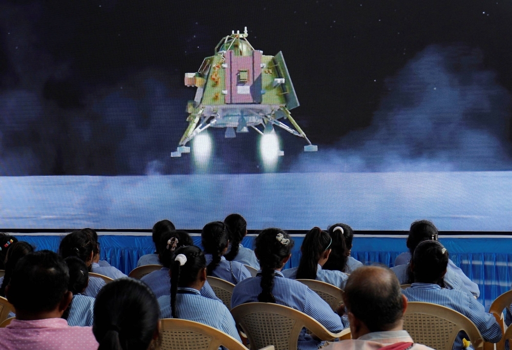 People watch a live stream of Chandrayaan-3 spacecraft's landing on the moon, at an auditorium of Gujarat Science City in Ahmedabad, India, Wednesday.