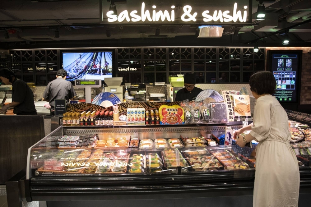 A customer shops at a sushi counter at the Food Le Parc supermarket in Hong Kong.