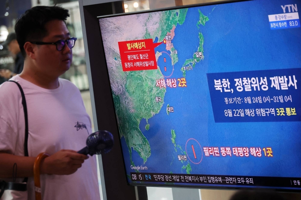 A man walks past a TV broadcasting a report about North Korea's failed rocket launch, at the main railway station in Seoul on Thursday.