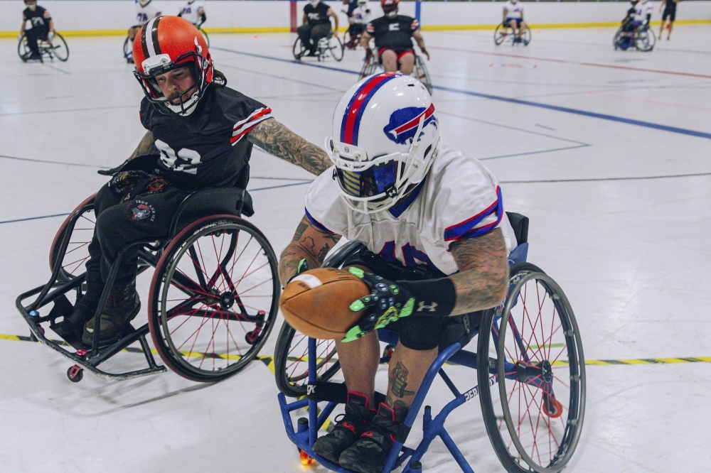 Matt Daniels of the Buffalo Bills Wheelchair Football Team moves with the ball during a scrimmage against the Cleveland Browns Adaptive Sports team in Cleveland on Aug. 5, 2023.