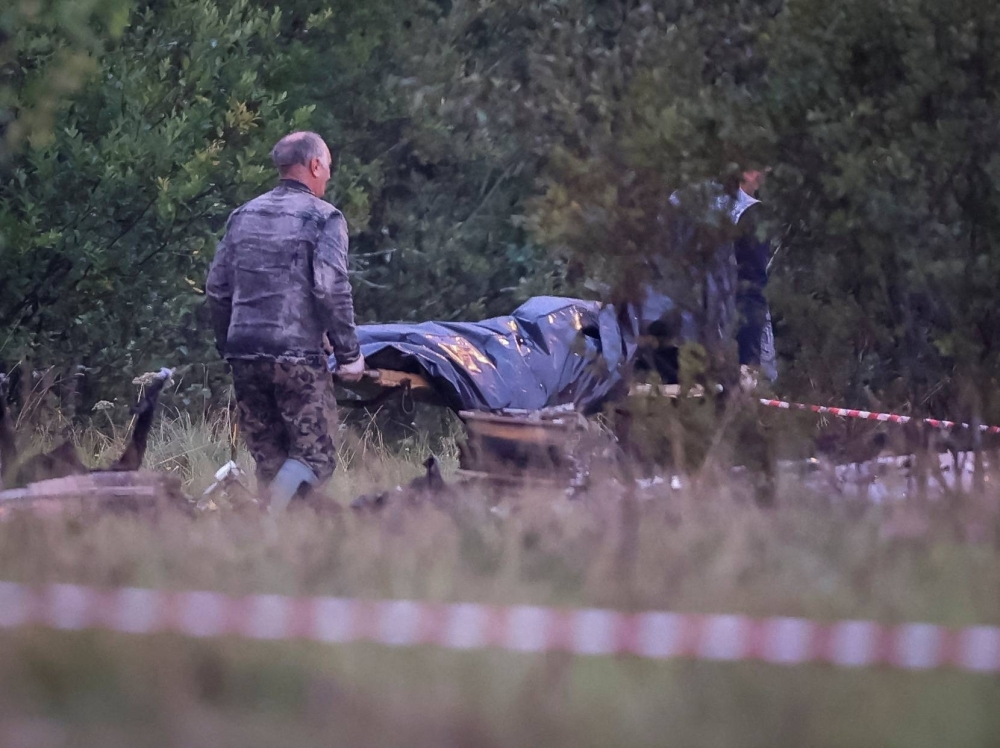 Emergency specialists carry a body bag near wreckage of the private jet that was believed to be carrying Wagner chief Yevgeny Prigozhin, at the crash site in Russia's Tver region on Thursday. 