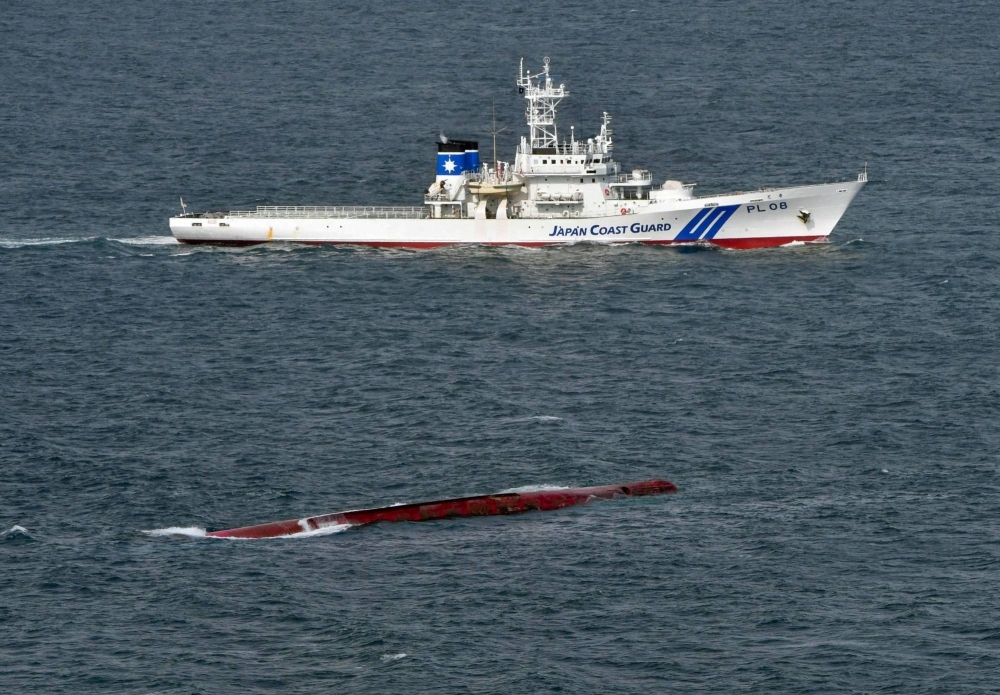 A Japan Coast Guard patrol ship conducts a search on Friday near the Izumi Maru, which capsized in the Kii Channel off Wakayama Prefecture.
