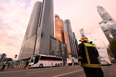A rescue worker stands next to a damaged building of the Moscow International Business Center following a drone attack in the Russian capital on Thursday.