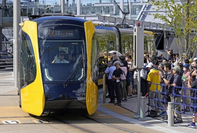 Passengers board Utsunomiya's new tram system near Utsunomiya Station on Saturday. 