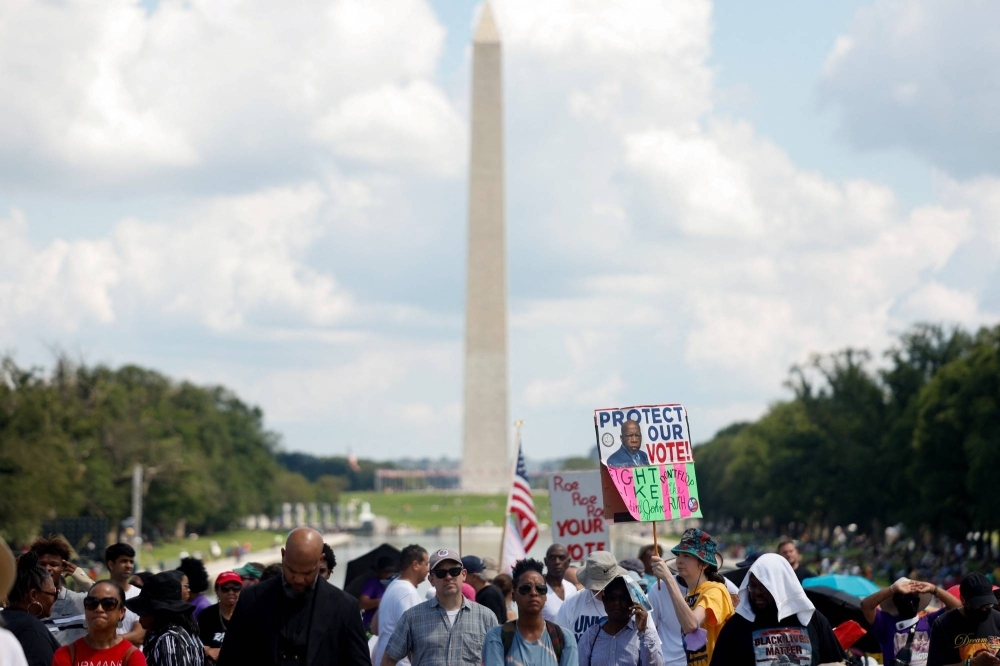 Demonstrators for racial justice gather on the 60th anniversary of Martin Luther King Jr.'s historic "I Have a Dream" speech in Washington on Saturday. 