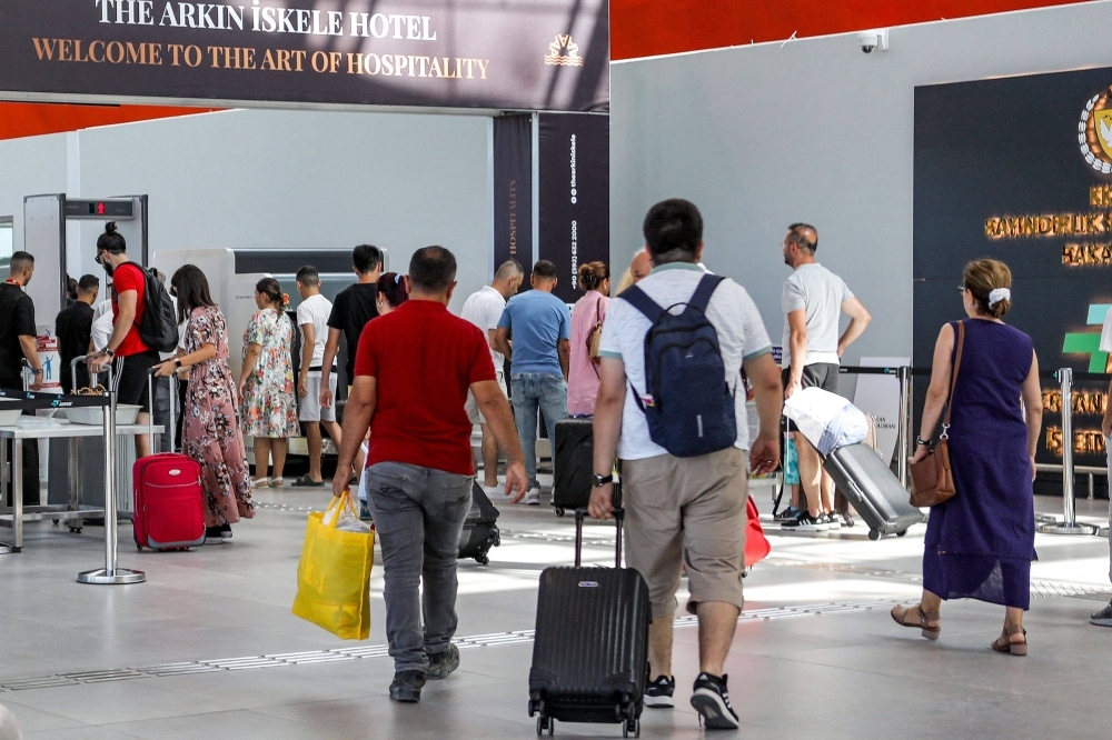 Travelers arrive for security checks at the newly-inaugurated terminal of Ercan airport outside Nicosia in the self-declared Turkish Republic of North Cyprus on July 21
