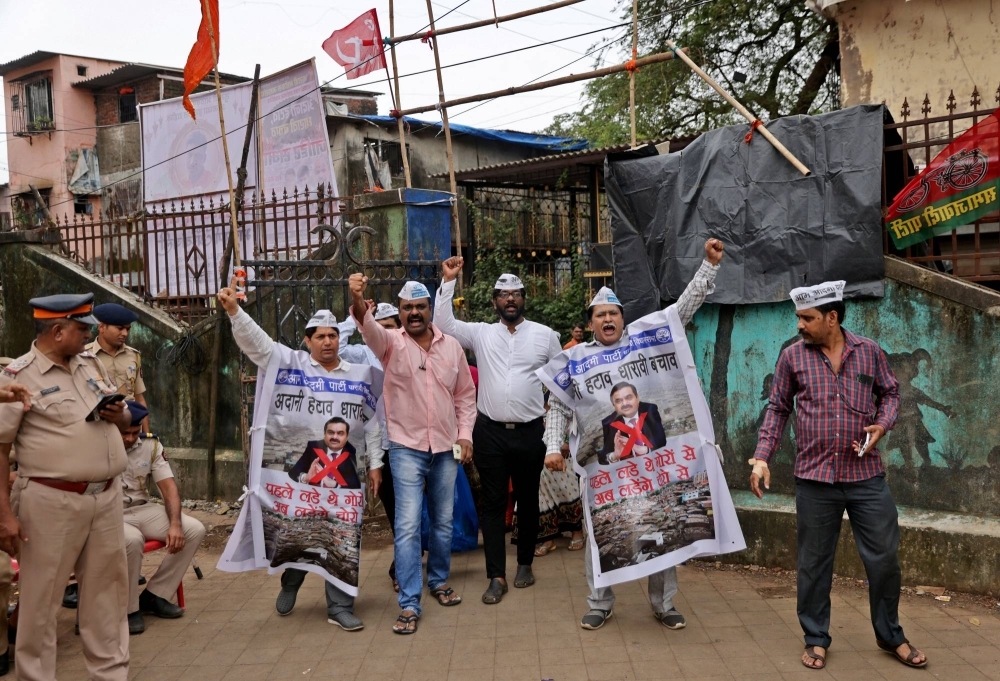 A protest against the redevelopment of Dharavi, one of Asia's largest slums, in Mumbai. Banners read: "Remove Adani, Save Dharavi" and "First we fought the whites now we fight the thieves".