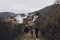 Visitors walk around natural geothermal manifestations at Furmarole park in Sasso Pisano, Italy. | Bloomberg
