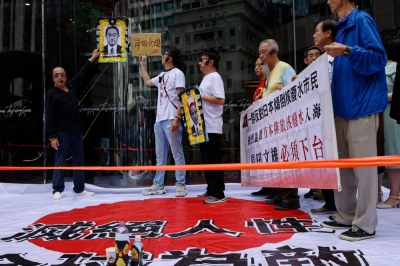 People protest after Japan moved to release treated radioactive water from the crippled Fukushima No. 1 nuclear plant into the sea, in Hong Kong on Thursday.