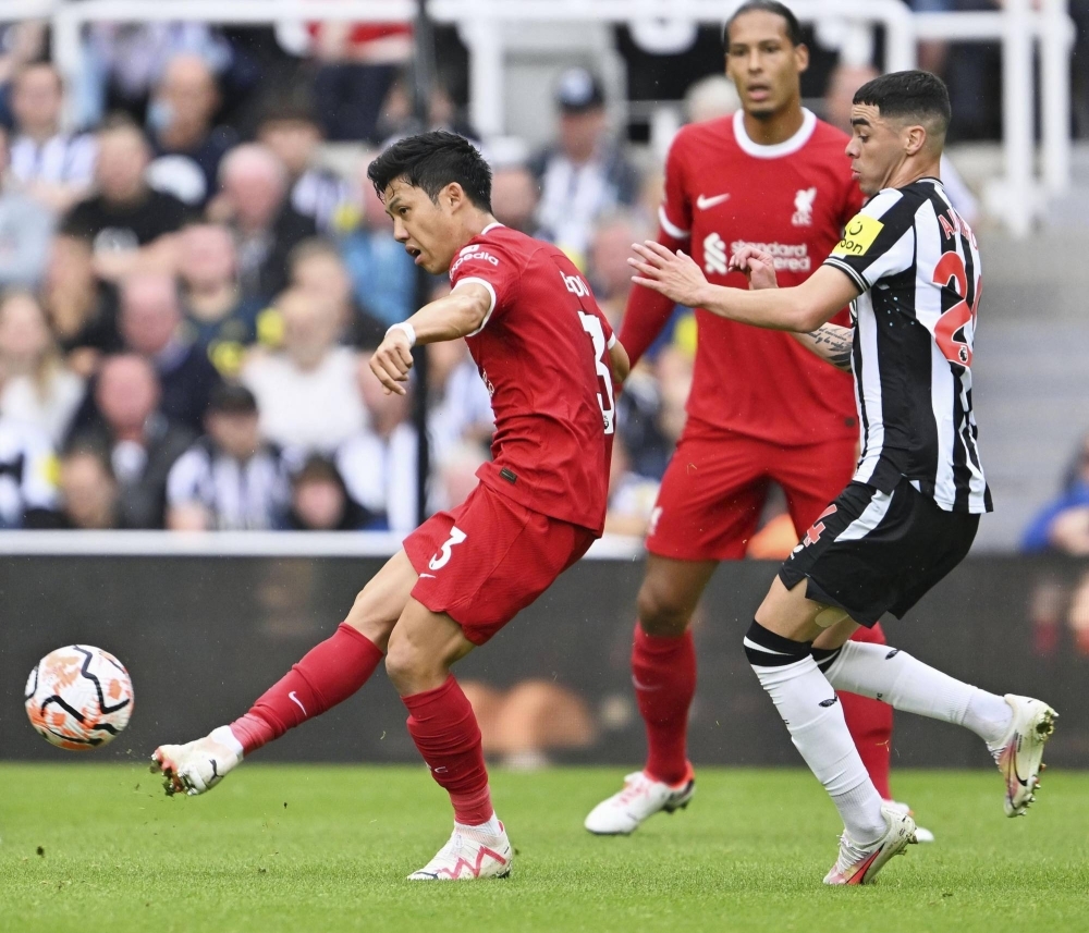 Liverpool's Wataru Endo (left) passes the ball during a Premier League match against Newcastle at St. James' Park in Newcastle, England, on Sunday.