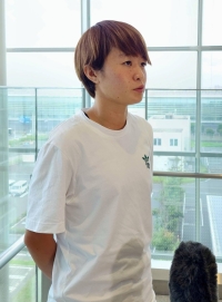 Japan striker Hinata Miyazawa speaks to reporters at Tokyo's Haneda Airport on Monday. | Kyodo