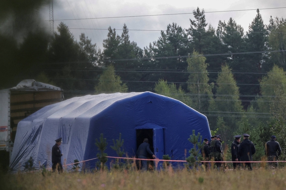 Police officers keep guard at a checkpoint near the site of the crash of a private jet linked to Wagner mercenary chief Yevgeny Prigozhin in the Tver region, Russia, on Aug. 24.